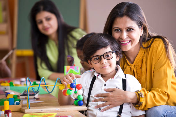 Happy teacher embracing preschool student Happy teacher embracing preschool student